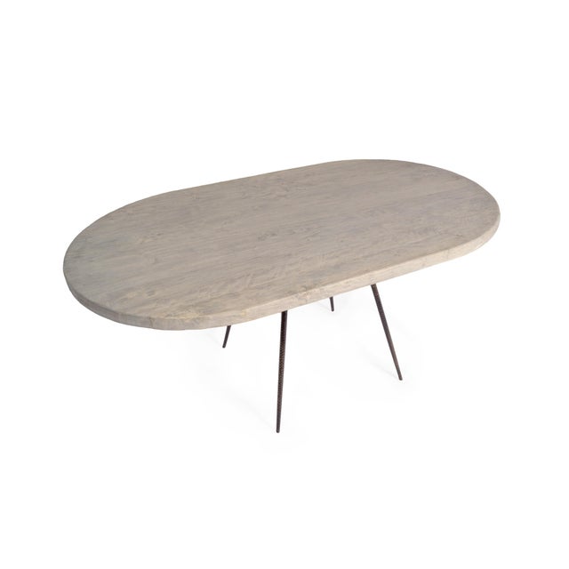 This one of a kind race-track shape elm table top features a cool, soft hue and pairs perfectly atop the hammered base...