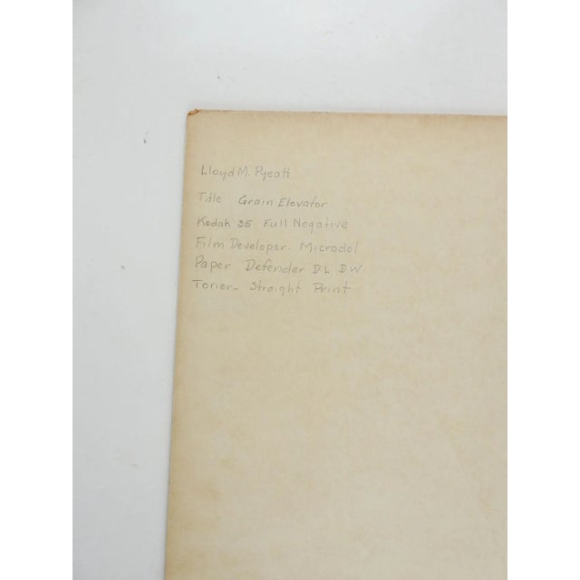 1950's black and white photograph by Lloyd M Pyeatt (Texas Photographer and 1Geologist) of a large grain elevator complex....