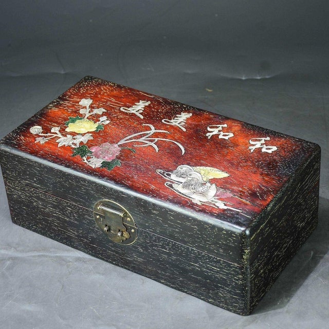 This beautifully crafted rectangular box features a striking two-tone design: a rich, textured black wood grain base with...