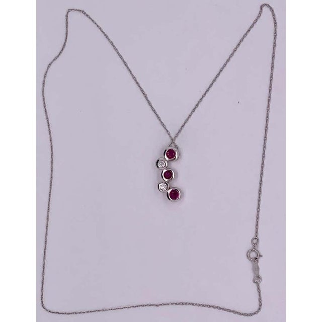 14kt Gold 3 Ruby and 2 Diamond, .14TDW Necklace 4 Grams Total on a 16 inch Necklace.