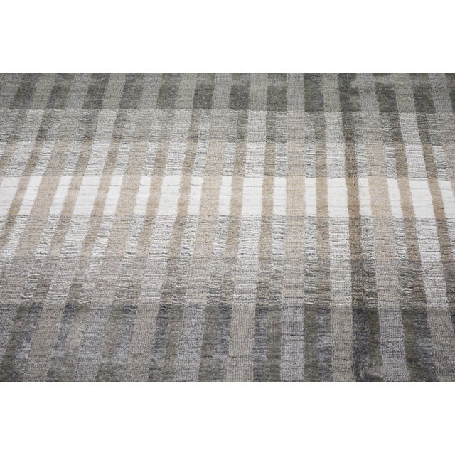 Hand-knotted with care using traditional rug making techniques, this wool rug blends timeless craftsmanship with a modern...