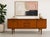 Mid Century Modern Teak Sideboard by Elliots of Newbury, Made in England, c. 1960’s showcasing clean lines and exceptional...