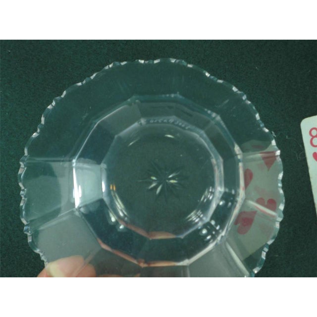 This product is a set of two antique Kosta Boda glass bowls, made in Sweden in the early 20th century. The bowls are round...