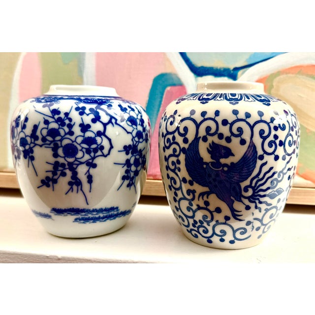 A charming pair of petite blue‑and‑white porcelain jars, each measuring 4" wide and 4.25" tall. These small jars feature...