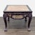 Carved wood table with a pink marble top. The legs have unique carved deity motifs, and the apron features carved center...