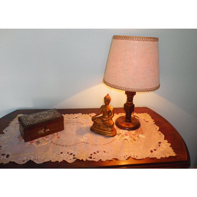 Table lamp with a wooden base featuring geometric designs, 1970s, France. The lampshade is made of ecru/beige fabric with...