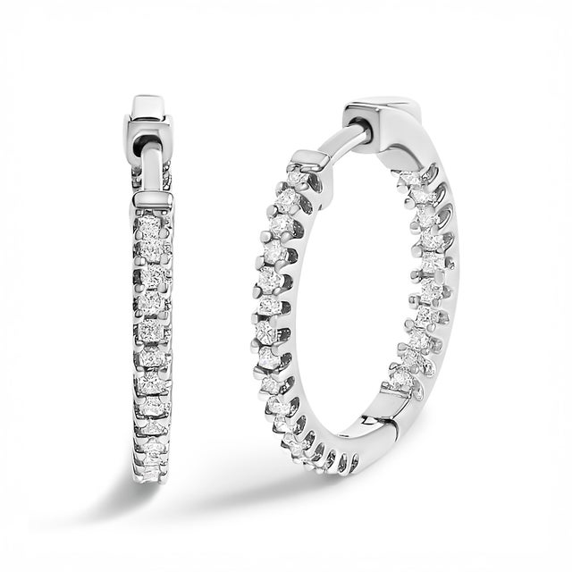 Exquisitely crafted from rhodium-plated .925 sterling silver, these hoop earrings epitomize modern elegance with a touch...