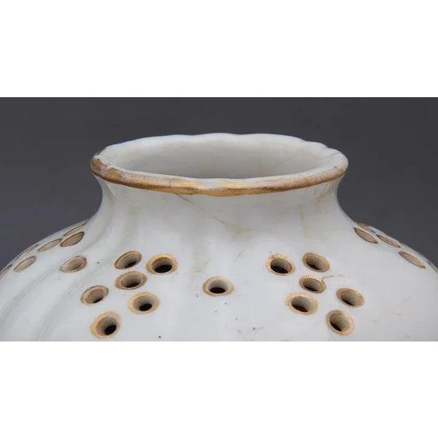 Pair of Continental porcelain potpourri covered urns with painted birds, insects and flowers enhanced by gilding in the...