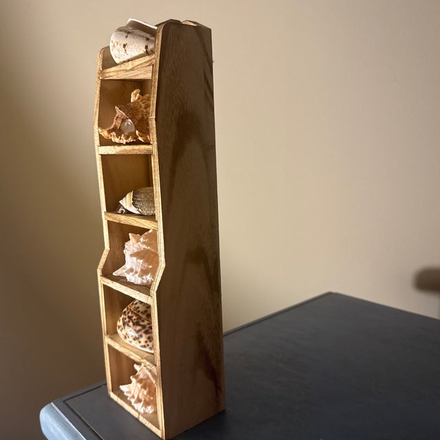 A selection of natural maritime wonders. The vertical column shelf is hand-crafted from richly grained planks of solid...