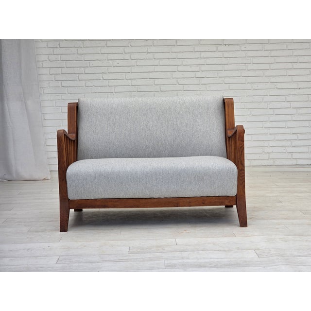 1950s, Scandinavian 2-seater sofa. Reupholstered in quality furniture wool. Renewed oak, brass springs in the seat and...