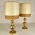 Pair of elegant 1970's table lamps. The bases are in brass and the base is part covered by ochre suede. The hand made...