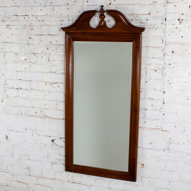 Marvelous vintage Chippendale style wall mirror composed of a walnut toned wood rectangular frame with an arched and...
