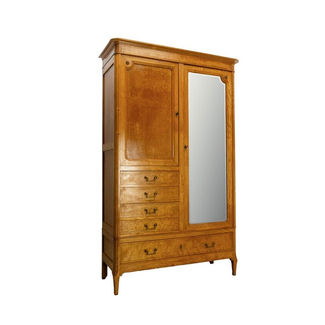 French two doors cabinet. A bevelled mirror on the central door. An elegant storage cabinet made of solid ash and burl ash...