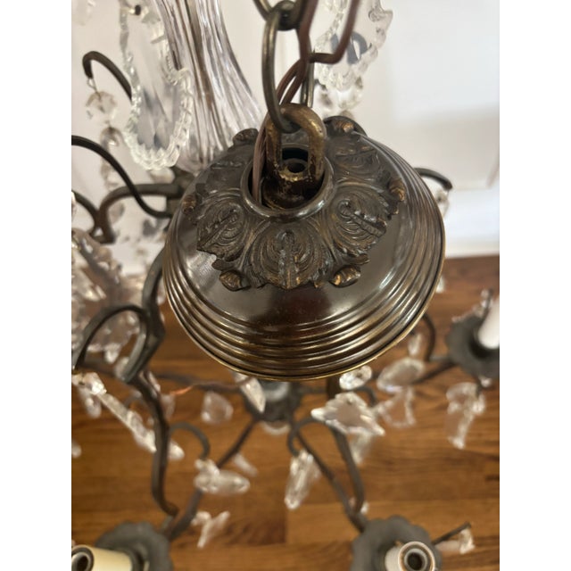 Stunning Louis XV style bronze or brass chandelier with beautiful prisms throughout. The perfect size for so many...