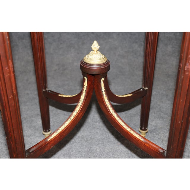 This elegant French Louis XVI style bronze-mounted occasional table, dating from the late 19th to the early 20th century,...