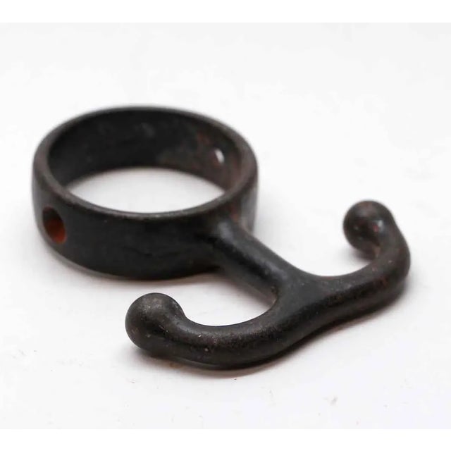 Cast iron hook with a round base and a black finish. Priced each. The manufacturer and exact date of creation are unknown....