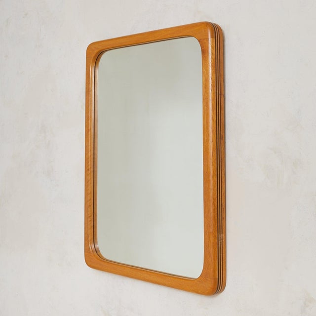 Handcrafted in France in the 1960s, this wall mirror is defined by gentle curvature and thoughtful detail. Its rounded...