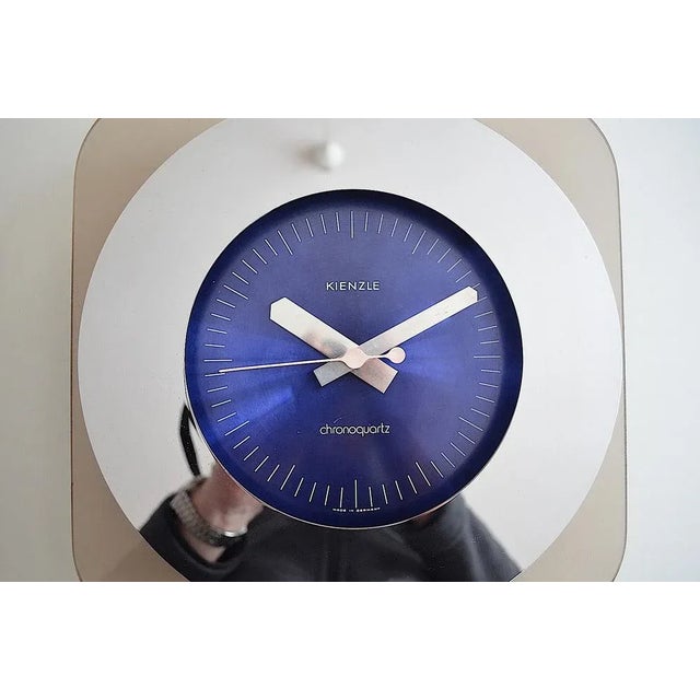 Space wall clock from the company Kienzle from the series Chromoquartz. The clock has a fairly transparent design and is...