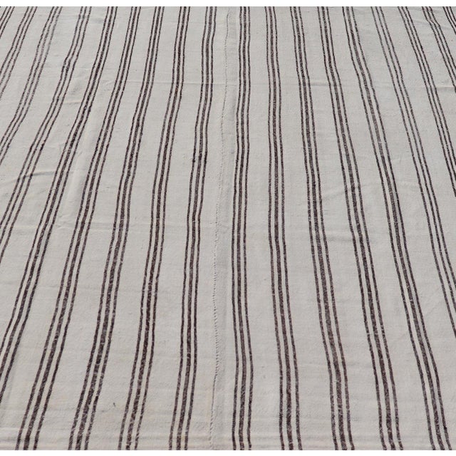 Measures: 7'5 x 8'3 Vintage Turkish Kilim with Stripes in Ivory and Shades of Brown. Country of origin: Turkey; Type:...