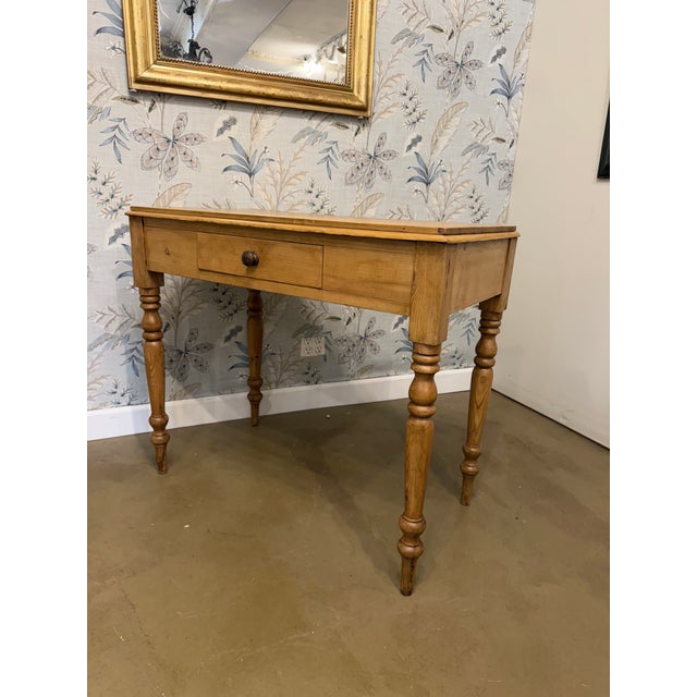 This is a English pine side table or great desk with storage drawer, resting on four lovely turned legs. The warm patina...