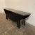 Mid-century modern drop leaf dining table. The sides fold up and the legs swing out to create an oval dining table. Or...
