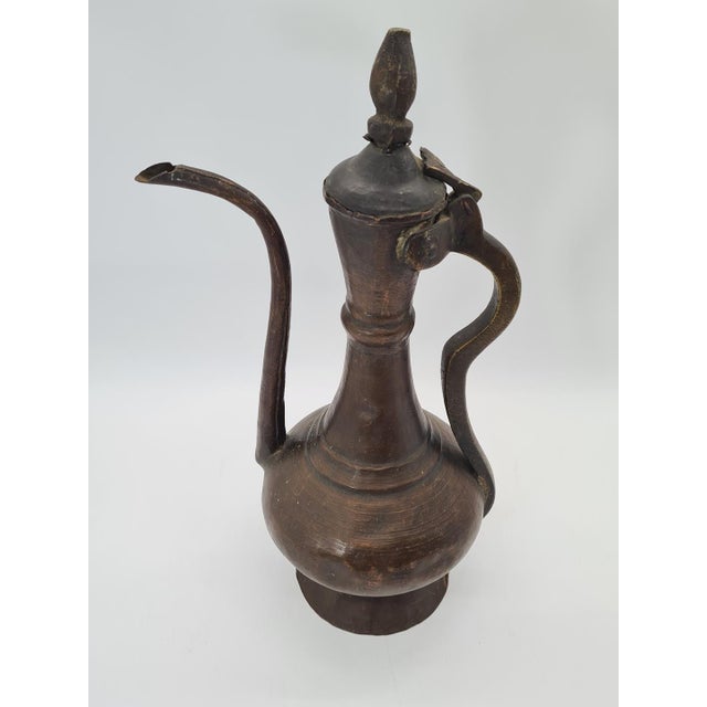 An antique, handcrafted copper ewer (ibrik / aftaba), most likely originating from the Ottoman cultural sphere—presumably...