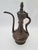 An antique, handcrafted copper ewer (ibrik / aftaba), most likely originating from the Ottoman cultural sphere—presumably...
