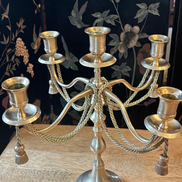 Beautiful 1980s brass five-arm candelabra with tassels. Recently polished to restore its shine. Please see condition...