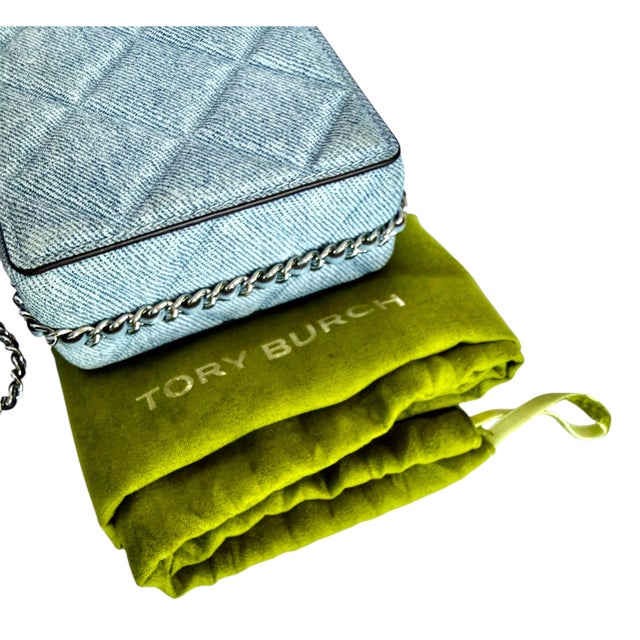 Crafted of quilted denim-printed suede, Tory Burch's Fleming phone crossbody bag features a leather interwoven chain-link...