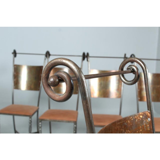 Eight wrought iron chairs in very good condition. Profiled round legs with central bracing. The applied seat is removable...