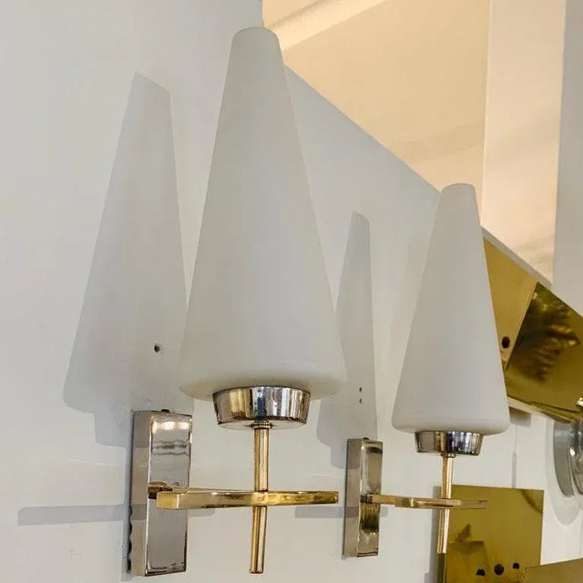 An excellent pair of 1970s French brass and polished chrome sconces with white opaline glass cone shades. Rewired. listing...