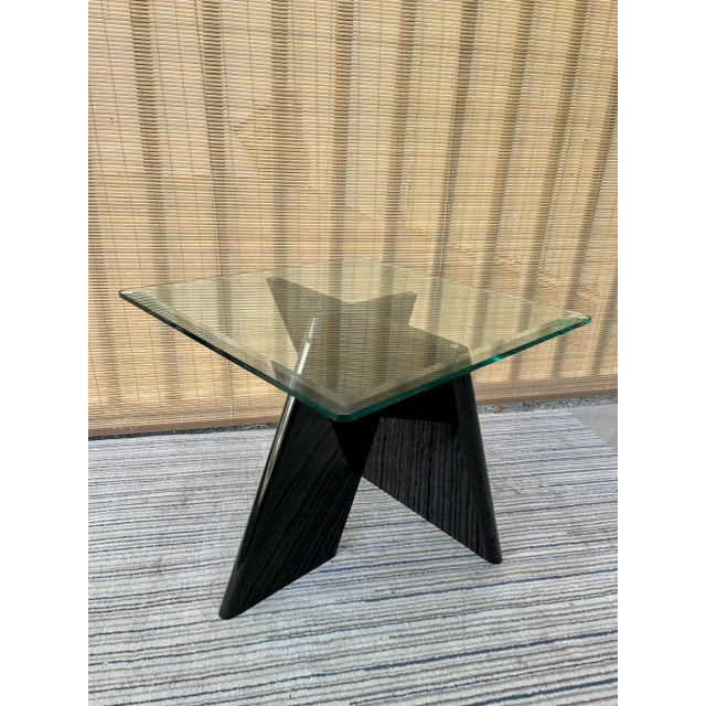 Vintage Black Lacquer Postmodern Side Table. Circa Late 1970s. Features a geometric x-shape designed pedestal with a black...