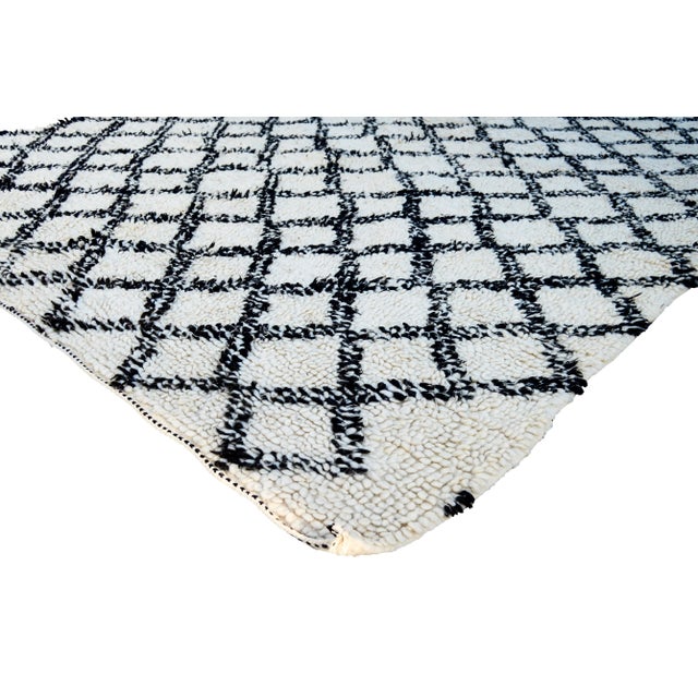 One-of-a-kind hand-knotted Moroccan rug in soft, organic wool with an ornate rhythmic pattern of Berber lozenge motif....