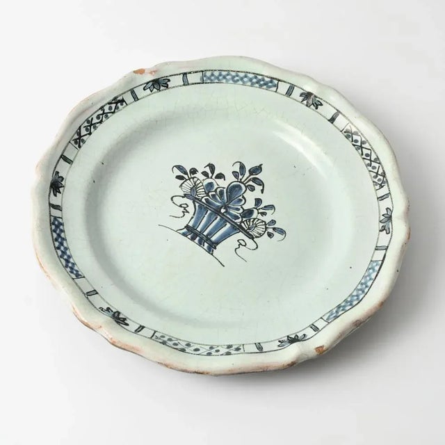 Antique hand-painted faience plate. This type of faience is called 'cul noir' due to its dark bottom. Made in the 18th...