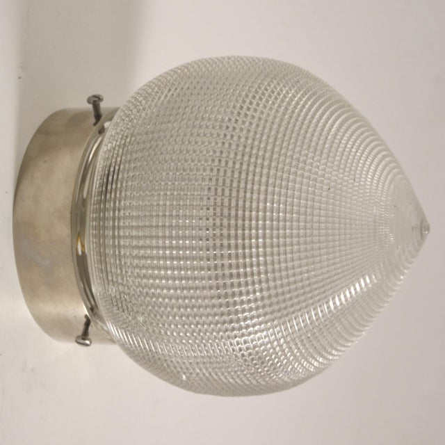 This ceiling light was manufactured by Holophane. It is made of nickeled metal and glass and has been rewired. Glass...