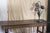 A tall and heavy lamp with 3 flowers that come from a circular base. Hollywood Regency style with a heavy base metal....