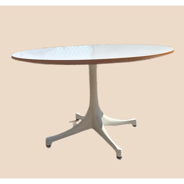 Classic Herman Miller Pedestal Table White laminate top with natural maple edge. Powder-coated, four-pronged, single...