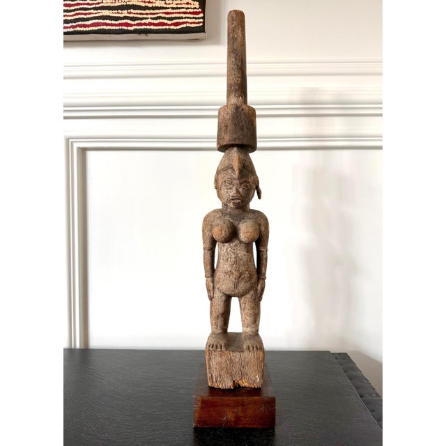 A carved wood female Madeö divination figure by Senufo artist, Ivory Coast circa first half of 20th century. The figure...