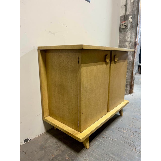 A refined and highly collectible “Bali Hai” cork top cabinet by American of Martinsville, embodying the relaxed...