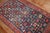 An early 20th century Caucasian Karabagh rug featuring a non-traditional motif in lively colors. The field is navy, green...
