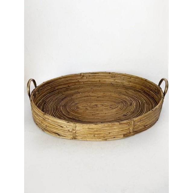 Woven rush tray with brass handles, a beautiful French handcrafted piece from the 1960s, combining natural beauty and...