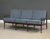 A mid century modern walnut color sofa with new blue fabric cushions made by Baumritter which was later bought out by...
