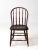 This antique Windsor-style chair features a gracefully arched back with finely turned spindles and a shaped seat that...