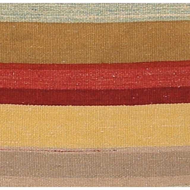 Sand and brown striped kilim floor pillow by Arteverk, 26 x 26 inches: a reversible kilim handwoven in Pakistan from wool...