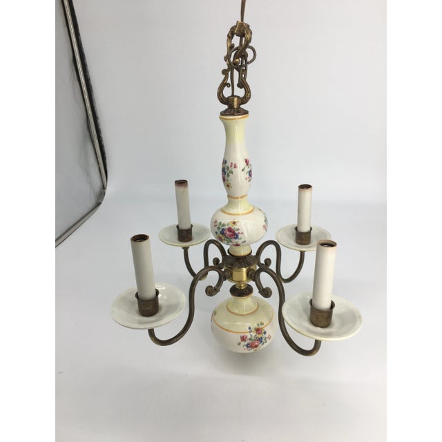 This is a beautiful old chandelier with lovely floral detail and brass accents was obtained at a turn of the century home...