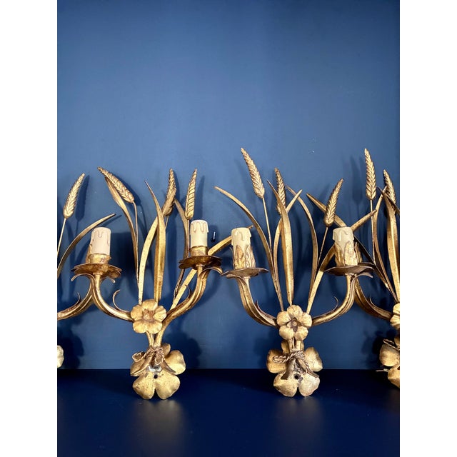 Four gilt metal wall sconces by Maison Charles. In perfect condition. Electrical connection checked and fully functional....