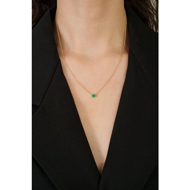 This minimalist pendant necklace featuring a 0.41 carat acrafted in 14K yellow gold. The emerald measuring approximately...