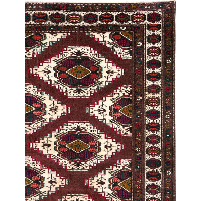 A vintage Central Asian Turkoman carpet from the mid-20th century. Measures: 6' 7" x 10' 10"