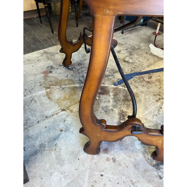 This is a striking pair of Italian burl walnut demilune console tables with iron stretchers. They are Italian and most...