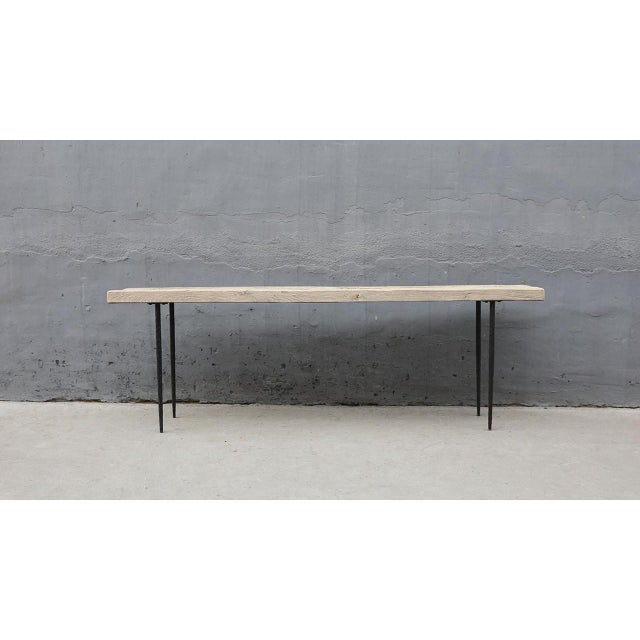 This extra-long vintage console table pairs the warmth of elmwood with the industrial strength of metal legs. Its...